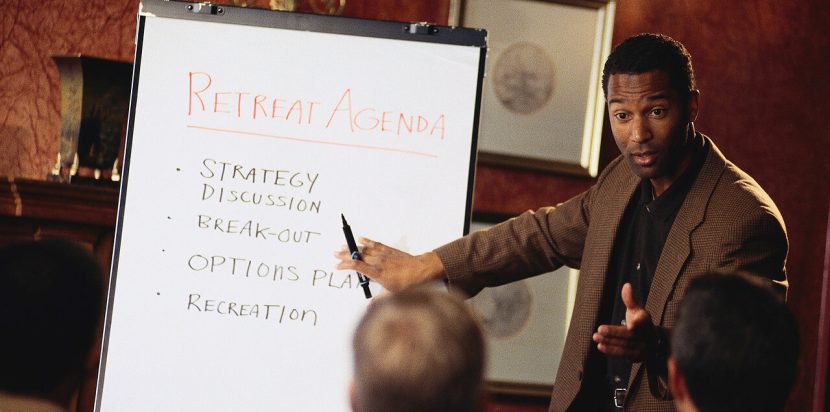 Businessman explaining retreat agenda